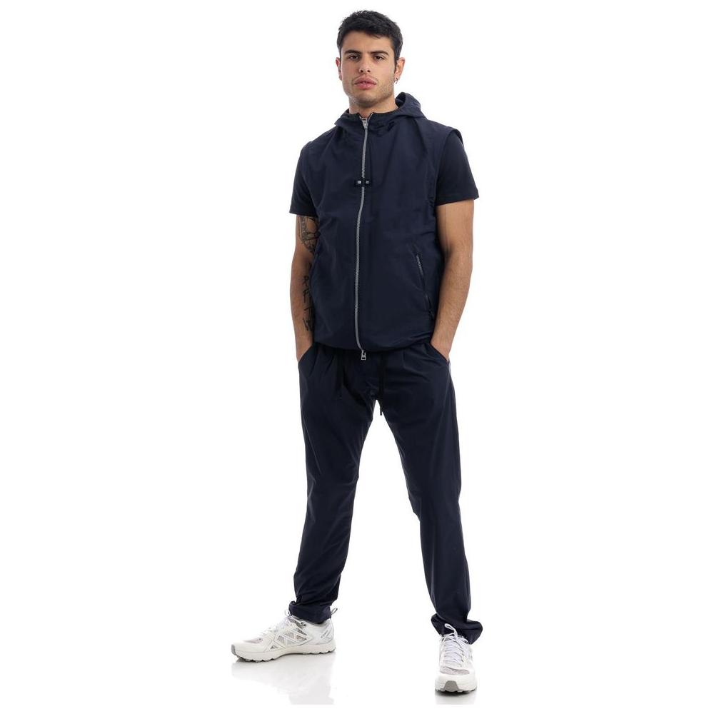 Herno blue nylon jacket with hood, removable sleeves and two side pockets, modeled by a young man.