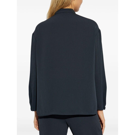 Back view of midnight blue Emporio Armani shirt with side slits, long sleeves, and band collar featuring a concealed button fastening.