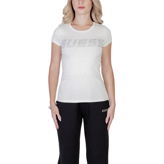 Woman wearing Guess Active KIARA short-sleeve cream cotton t-shirt with embossed logo, highlighting a comfortable, stylish fitted design.