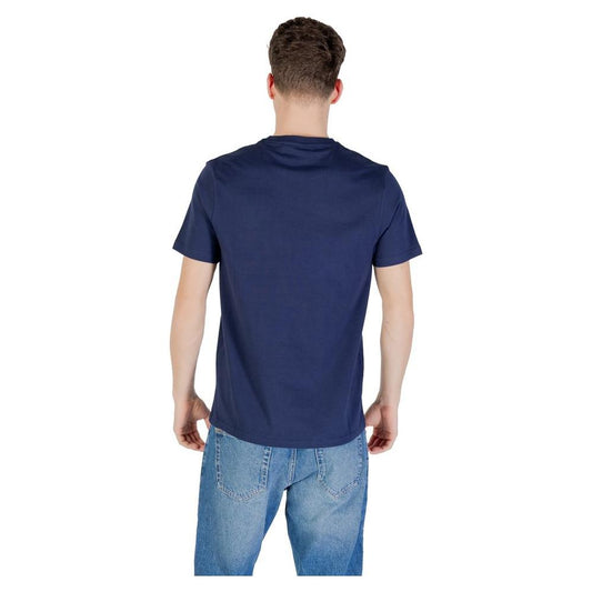 Back view of a man wearing a Lyle & Scott Blue Cotton T-Shirt paired with jeans, showcasing the shirt's modern fit and clean design.